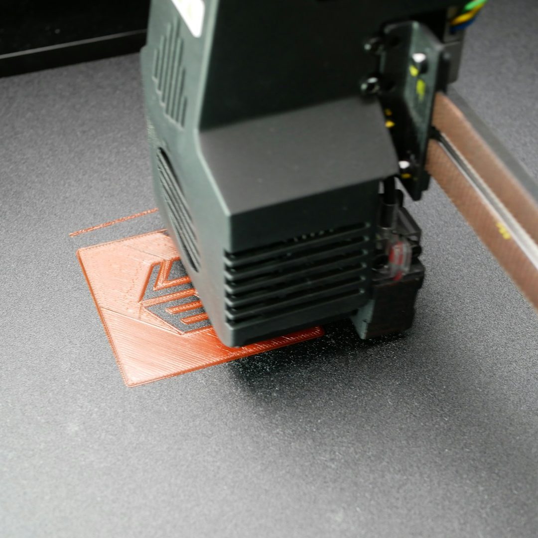 Impression 3D Imprimante 3D en cours de fabrication d'un objet en plastique rouge.